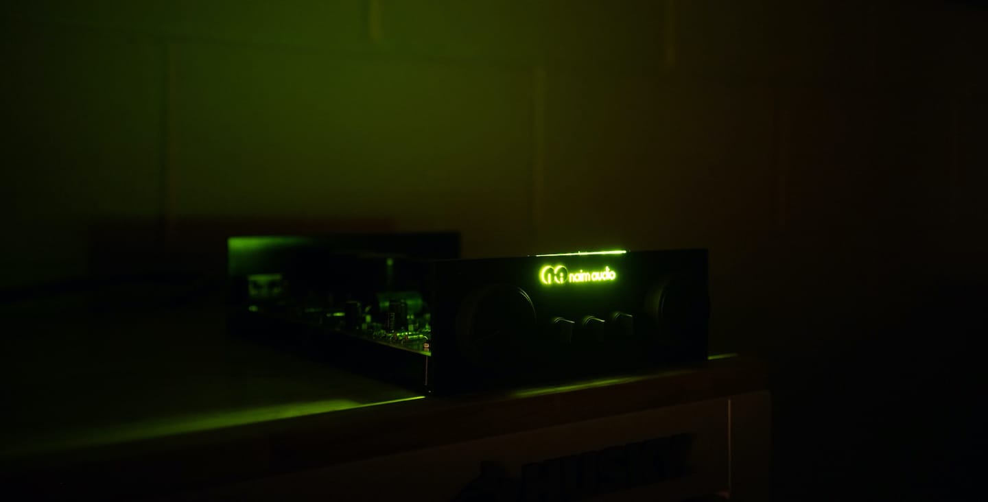 The author's system in the dark, its Naim logo lit green